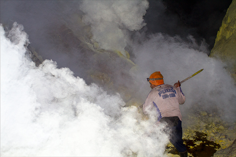 Workers mine sulfur from the volcano